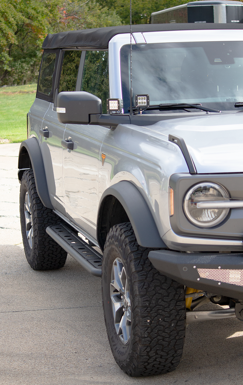 Load image into Gallery viewer, Alt text: &quot;2022 Ford Bronco equipped with Fishbone Offroad Step Sliders, showcasing the accessory&#39;s fit and integration on the vehicle&#39;s side profile.&quot;
