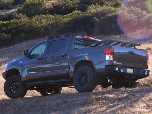 2007-Current Toyota Tundra Crew Max with installed Front Runner Slimline II Load Bed Rack Kit parked on a hillside