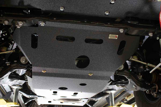 Alt text: "Fishbone Offroad Skid Plates installed on 2016 Toyota Tacoma undercarriage for enhanced protection while off-roading."