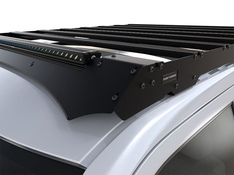Load image into Gallery viewer, Front Runner Slimsport Roof Rack Kit for Ford F-150 Super Crew 2015-2020 with integrated light bar option, mounted on vehicle roof.
