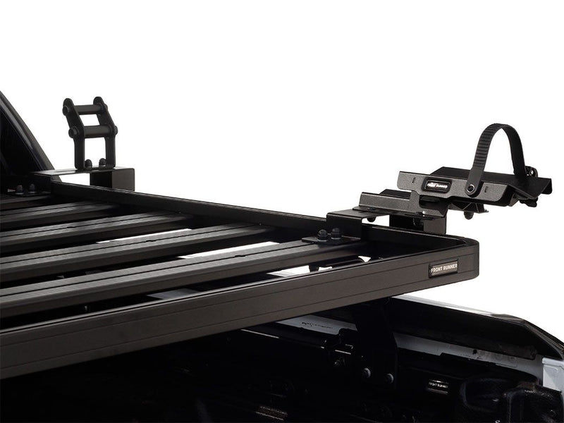 Load image into Gallery viewer, Close-up of Front Runner Load Bed Rack Side Mount for Bike Carrier installed on a vehicle, showcasing the secure bike holding system with black robust design.
