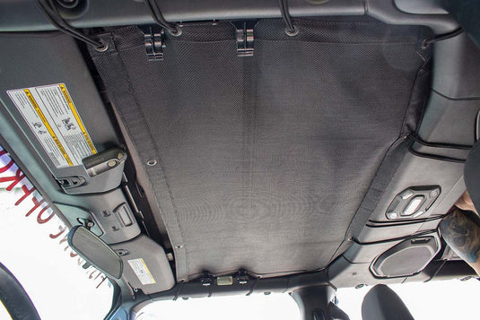 Fishbone Offroad sun shade installed in Jeep Wrangler JL interior view, blocking sunlight for comfortable driving experience.