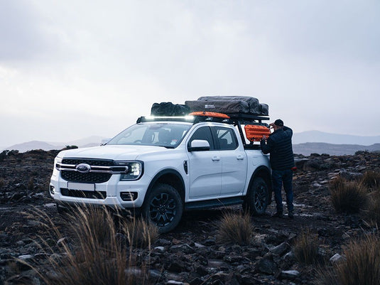 Ford Ranger T6.2 Wildtrak/Raptor Double Cab with Front Runner Pro Bed Rack Kit and Roof-Top Tent in Rugged Terrain