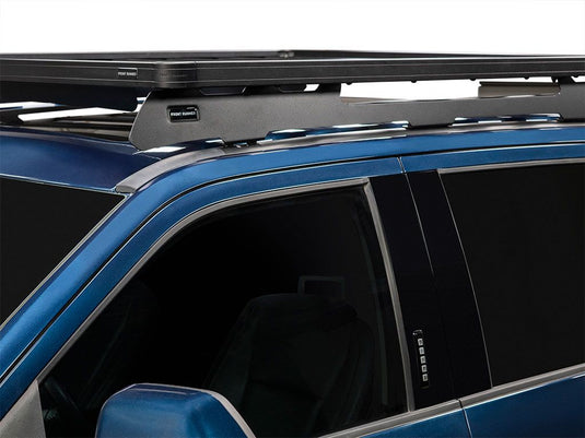 Front Runner Slimline II Roof Rack Kit installed on blue Ford F250 Super Duty Crew Cab showing tall profile and secure fit.