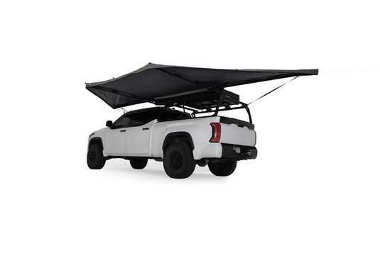 "White pickup truck with Freespirit Recreation 180 Degree Awning open over truck bed on isolated background"