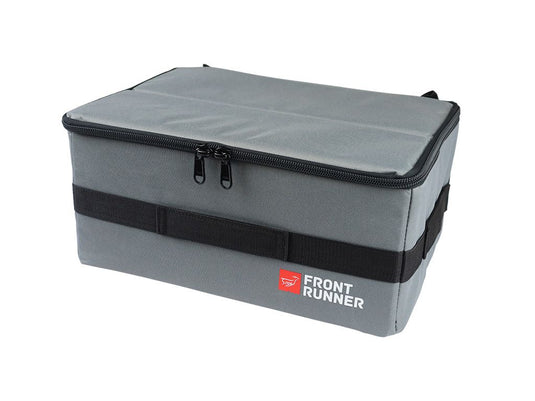 Alt text: inchFront Runner Flat Pack storage container in gray with brand logo, durable zippers, and carrying straps.inch