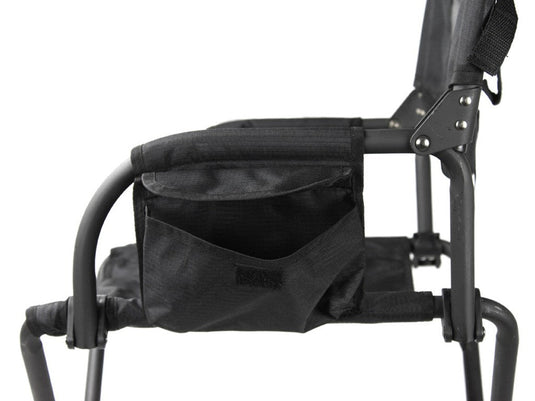 Close-up of black Front Runner Expander Camping Chair showing the seating area, armrest, and storage pocket detail.