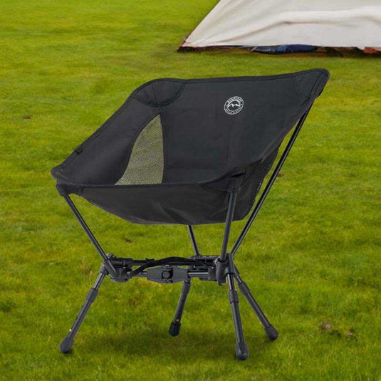 "Overland Vehicle Systems compact camping chair with collapsible aluminum frame on grass with tent in the background"