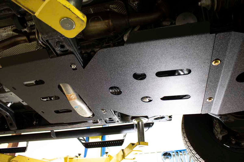 Load image into Gallery viewer, Alt text: &quot;Fishbone Offroad skid plates installed on a 2016-current Toyota Tacoma undercarriage for enhanced protection&quot;
