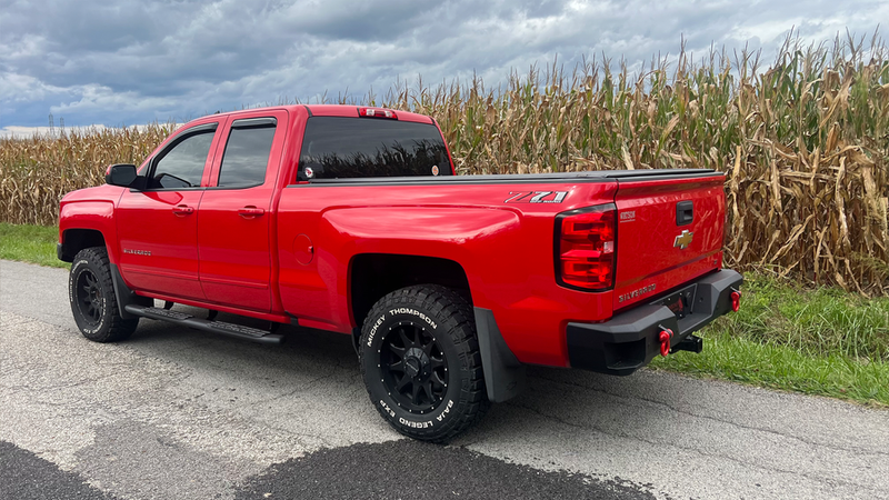 Load image into Gallery viewer, Red Chevrolet Silverado with Fishbone Offroad 5-Inch Oval Side Steps installed, 2014-2019 GMC Double Cab Pickup upgrade.
