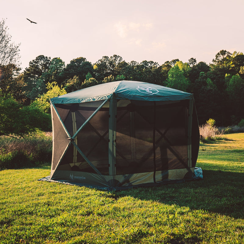 Load image into Gallery viewer, Gazelle Tents G6 6-Sided Portable Gazebo set up in the field with wind panels and brand logo visible.
