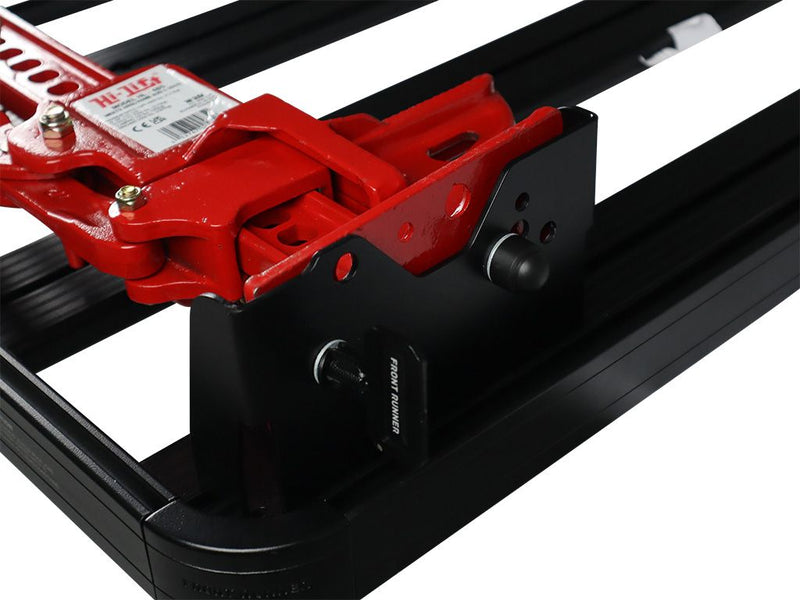 Load image into Gallery viewer, Alt text: &quot;Front Runner Hi-Lift Jack Bracket mounted on vehicle roof rack, featuring a red Hi-Lift Jack securely fastened with black top mount brackets.&quot;
