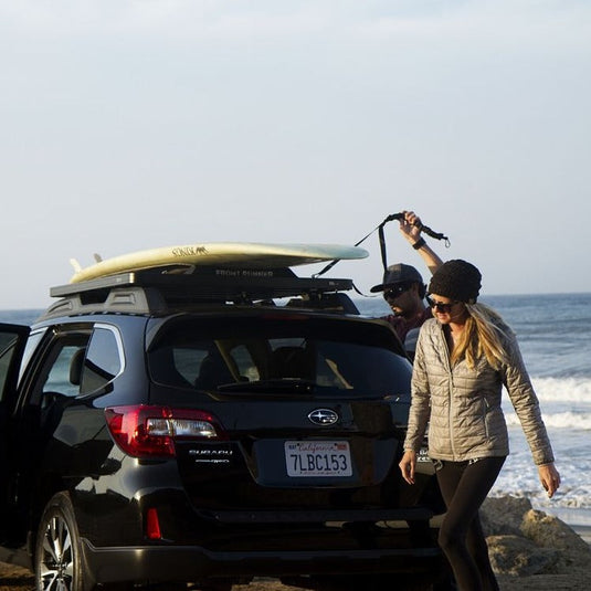 Front Runner Rack Pad Set on Subaru SUV with surfboard at beach