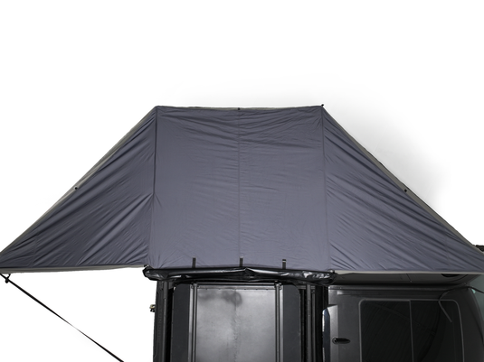 Freespirit Recreation 180 Degree Awning attached to vehicle rooftop for outdoor shelter.