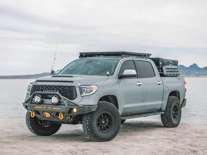 Load image into Gallery viewer, Toyota Tundra Crew Max with Slimline II Roof Rack Kit by Front Runner, low profile setup for off-road vehicle, 2007-current model shown with rack-mounted gear.
