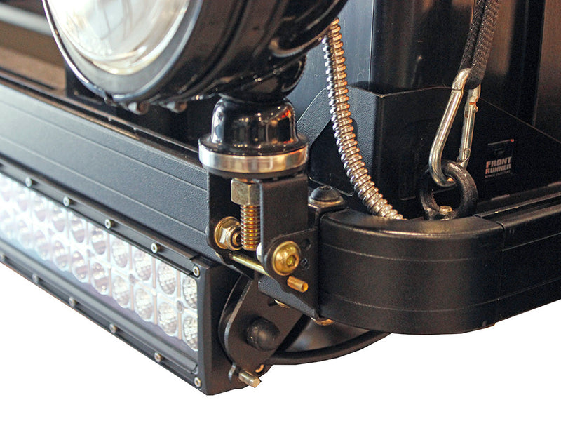 Load image into Gallery viewer, Front Runner Roof Rack Spotlight Bracket mounted on vehicle with attached spotlight and wiring.
