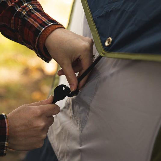 Person setting up a Territory Tents Jet Set 4 Hub Tent, showing tent assembly detail.