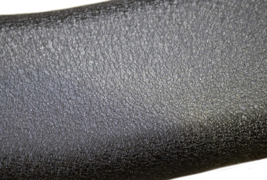 Close-up of the textured surface on the Fishbone Offroad 5-inch oval side step for Chevy/GMC Crew Cab trucks.