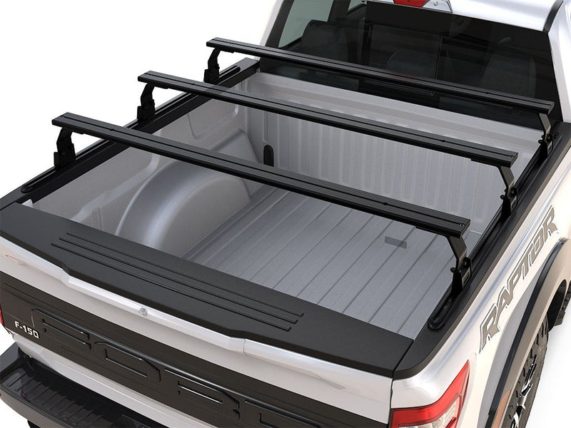 Load image into Gallery viewer, Front Runner Ford F150 Raptor 5.5&#39; 2009-Current triple load bar kit installed on truck bed for extra cargo carrying capacity.
