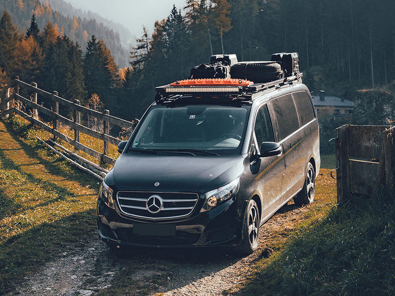 Load image into Gallery viewer, Mercedes van equipped with Front Runner Recovery Device Mounting Kit, roof rack and off-road gear parked in a scenic forest
