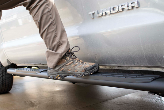 "Person stepping on Fishbone Offroad 2007-2021 Toyota Tundra Double Cab 5 Inch Oval Side Step"