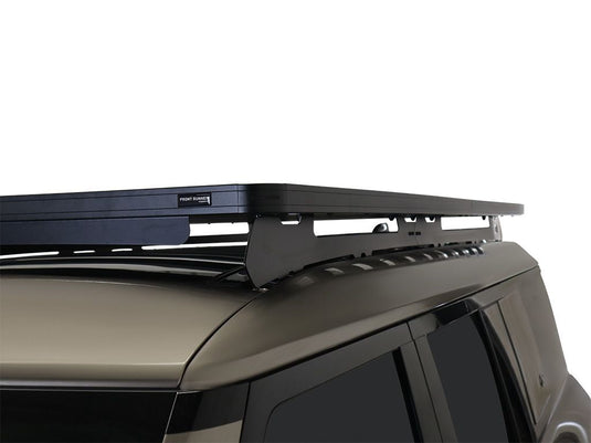 Alt text: Close-up of a Front Runner Slimline II Roof Rack installed on a Land Rover Defender 130, showcasing the sleek design and sturdy construction.