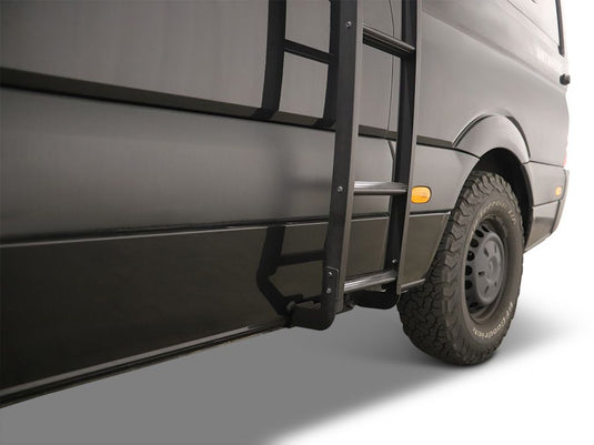 Alt text: "Front Runner Mercedes-Benz Sprinter H1 Slimpro Van Rack Ladder attached to the side of a gray van, showing a sturdy step for roof access."