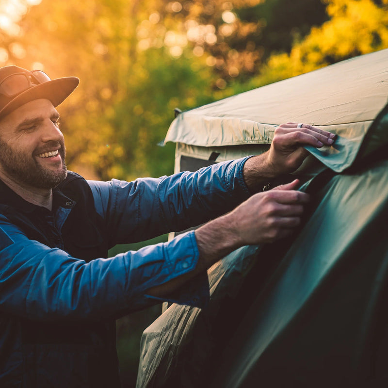 Load image into Gallery viewer, Man setting up a Gazelle Tents G6 6-Sided Portable Gazebo &amp; Wind Panel Combo in nature
