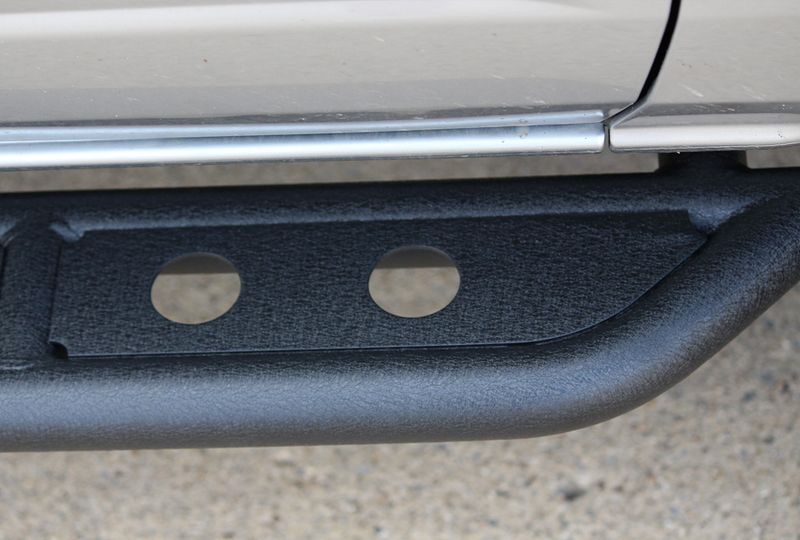 Load image into Gallery viewer, Alt text: &quot;Close-up of the Fishbone Offroad step slider installed on a 2022 Ford Bronco, demonstrating the texture and mounting design.&quot;
