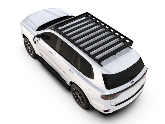 Alt Text: inchWhite Ford Everest 2022 with Slimline II Roof Rack Kit by Front Runner mounted on top, viewed from a high angle.inch