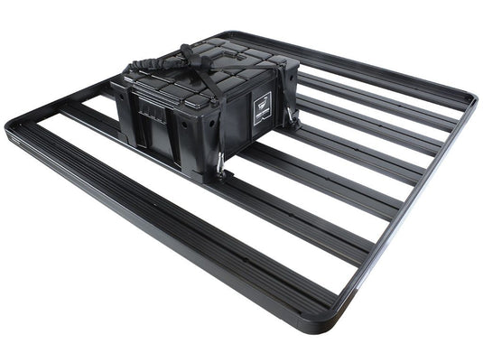 Alt text: "Front Runner Adjustable Rack Cargo Chocks securing a storage box on a vehicle roof rack system."