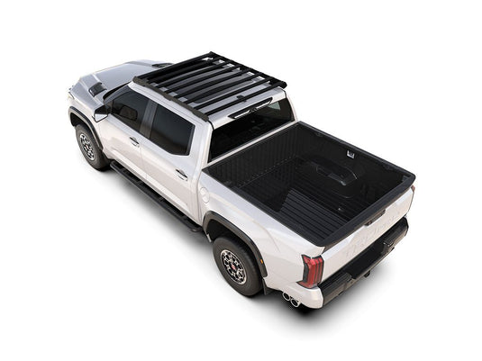 Alt text: "2022 Toyota Tundra Crew Cab equipped with Front Runner Slimsport Roof Rack Kit, showcasing the sleek design and cargo space enhancement on a white truck from a high angle view."