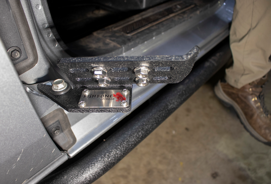 alt="Fishbone Offroad foot peg set installed on a 2022 Ford Bronco door, logo visible"