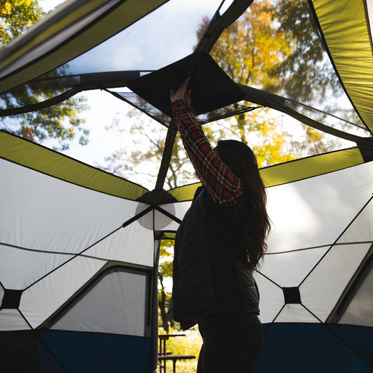 Person setting up a Territory Tents Jet Set 4 Hub Tent in the outdoors