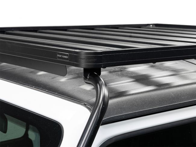 Load image into Gallery viewer, Close-up of a Front Runner Extreme Slimline II Roof Rack Kit installed on a Jeep Wrangler JL 4 Door, showcasing the solid build and mounting brackets.
