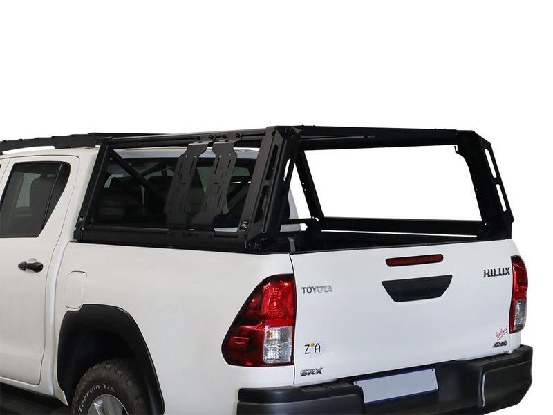 Load image into Gallery viewer, Alt text: &quot;Front Runner Pro Bed Universal Accessory Mount installed on a Toyota Hilux pickup truck&quot;
