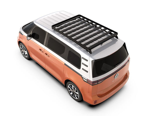 Alt text: "Orange and white Volkswagen ID Buzz equipped with a Slimline II Roof Rack Kit by Front Runner viewed from a high angle."