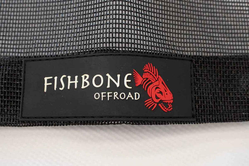 Load image into Gallery viewer, Alt text: &quot;Close-up of the Fishbone Offroad brand logo on a 2020-Current Jeep Gladiator JT Rear Sun Shade with mesh fabric background.&quot;
