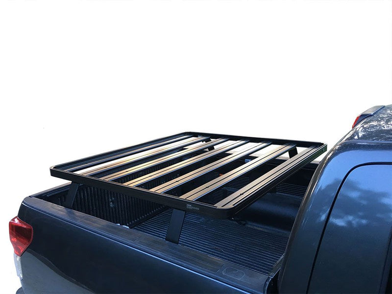 Load image into Gallery viewer, Front Runner Slimline II Load Bed Rack Kit installed on a Toyota Tundra DC 4-Door Pickup Truck, 2007-Current model, viewed from the rear angle highlighting the sturdy design and fit.
