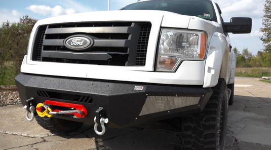 Alt text: inchFishbone Offroad Pelican Front Bumper on 2009-2014 Ford F-150 with tow hooks and LED light barsinch