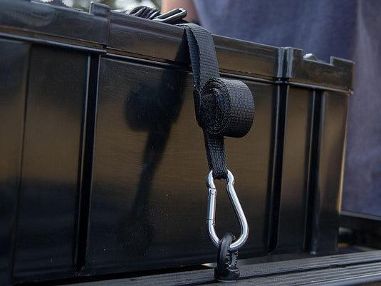 Front Runner Stratchit cargo tie-down strap with stainless steel carabiner attached to a vehicle roof rack