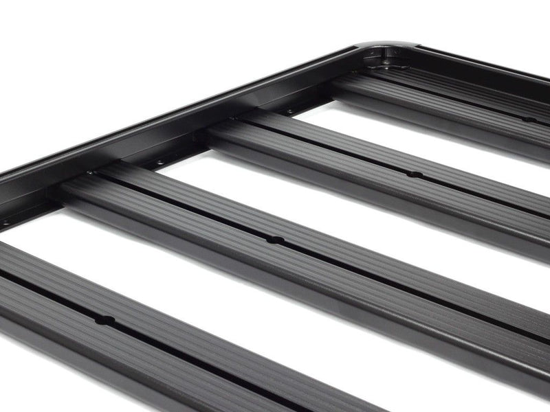 Load image into Gallery viewer, Close-up of black Front Runner Slimline II roof rack kit for Toyota 100 Series Land Cruiser and Lexus LX470 on white background.
