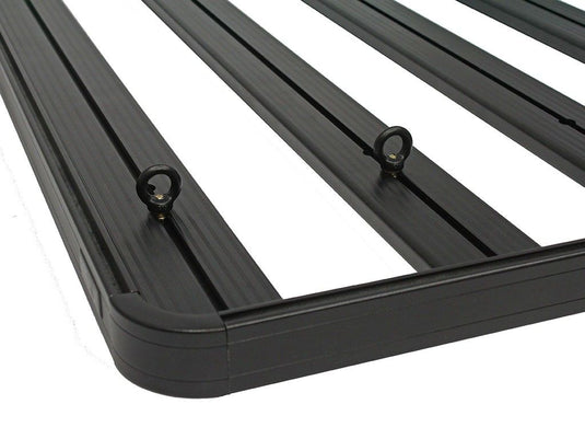 Close-up of black Front Runner tie down rings installed on a vehicle rack, designed for securing cargo.