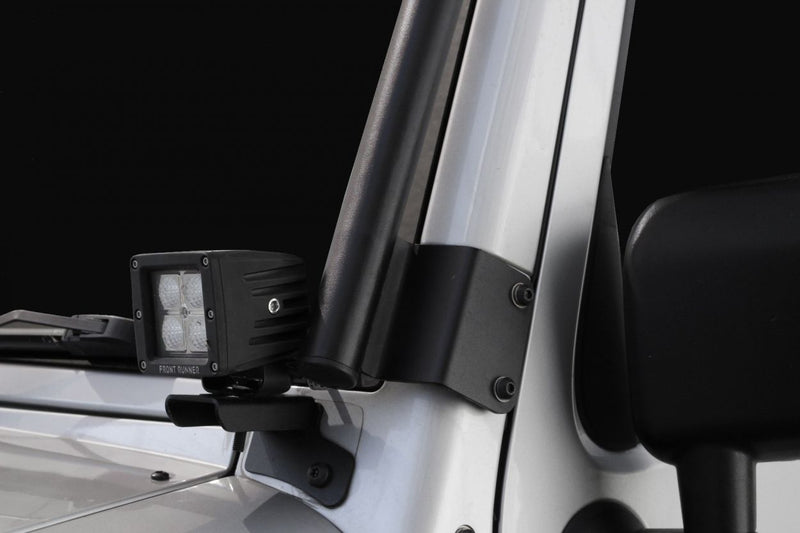 Load image into Gallery viewer, Close-up of Front Runner Extreme Roof Rack Kit mounted on a Jeep Wrangler JK 2 Door showing sturdy bracket and LED light accessory.
