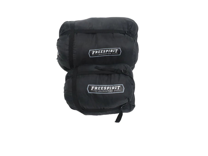 Load image into Gallery viewer, Freespirit Recreation branded black sleeping bag, compressed and strapped for camping.
