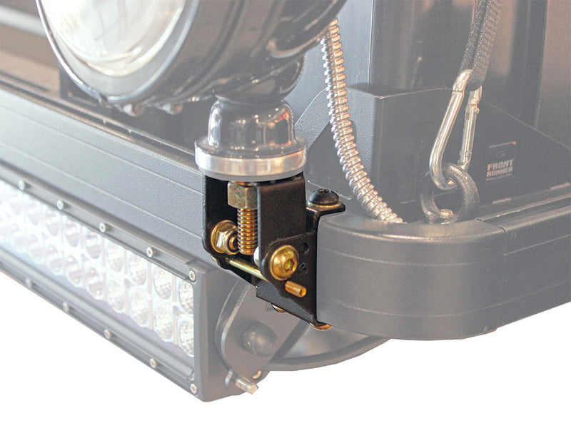 Load image into Gallery viewer, Close-up of Front Runner Roof Rack Spotlight Bracket attached to a vehicle&#39;s roof bar with a spotlight and wiring visible
