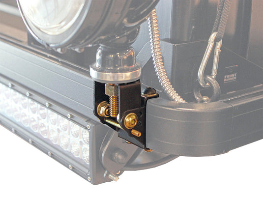 Close-up of Front Runner Roof Rack Spotlight Bracket attached to a vehicle's roof bar with a spotlight and wiring visible