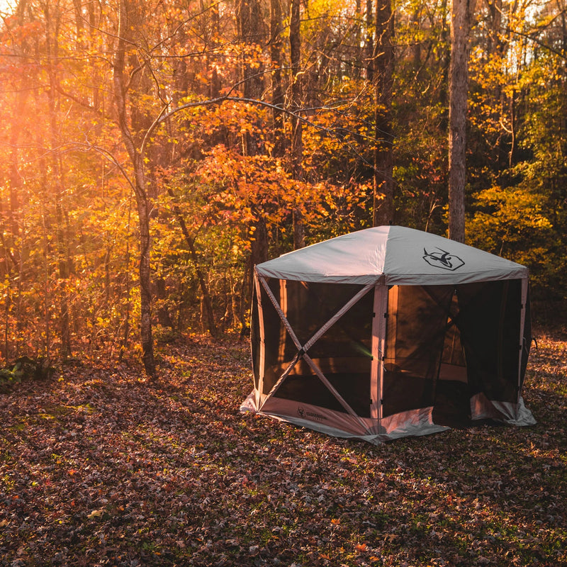 Load image into Gallery viewer, Gazelle Tents G6 6-Sided Portable Gazebo with Wind Panels set up in a forest clearing during autumn.
