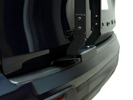 Close-up view of the Front Runner ladder mounted on the rear of a Toyota Sequoia 2023, showcasing the sturdy attachment and sleek black design.