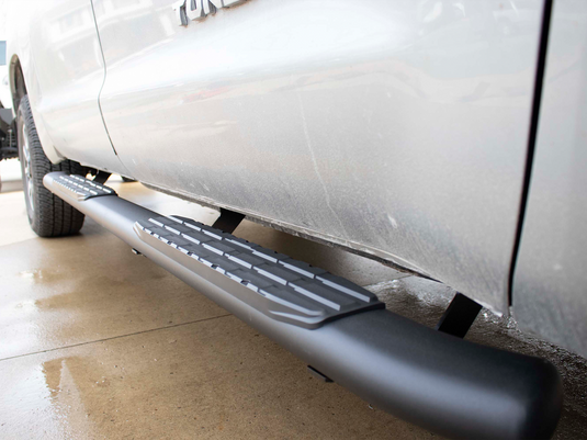 Alt text: "Close-up view of Fishbone Offroad 5 Inch Oval Side Steps installed on a 2007-2021 Toyota Tundra Crew Max Cab."